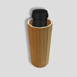 May include: A hexagonal wooden planter with a black plastic pot inside. The planter has a natural wood grain finish.