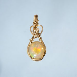 Ethiopian rainbow opal Pendant wire wrapped in gold