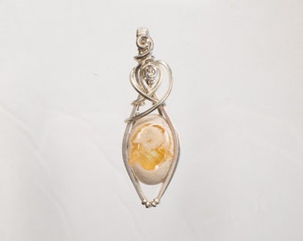 Mexican Fire Opal wire wrapped in Sterling Silver, you can see through it.
