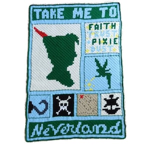 May include: A handmade, rectangular wall hanging featuring a Peter Pan theme. The design includes a green silhouette of Peter Pan, Tinkerbell, and the words "Take Me To Neverland". The color palette includes green, blue, white, and red.