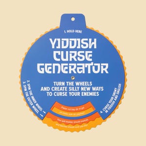 May include: A blue and orange Yiddish Curse Generator with white text. The text reads "Yiddish Curse Generator" and "Turn the wheels and create silly new ways to curse your enemies." The generator has a hole at the top for holding.