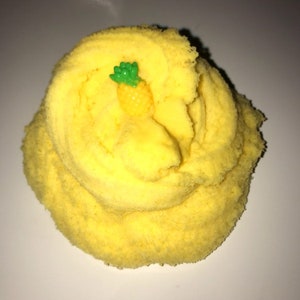 May include: Yellow slime with a small pineapple charm on top.