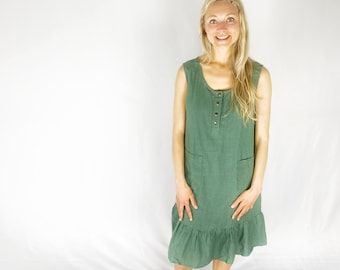 May include: A green sleeveless linen dress with a button-up front and a ruffled hem. The dress has two pockets on the front.