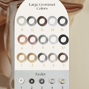 a collection of large ornamental rings in various colors, including white, black, silver, and gold, along with their corresponding eyelets.