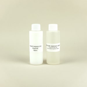 May include: Two white plastic bottles with labels. The bottle on the left is labeled "Yamato Indigo Dye Fixative 100ml". The bottle on the right is labeled "100% Pure Vinegar (100ml) For dye process only. Do not drink or use for cooking."