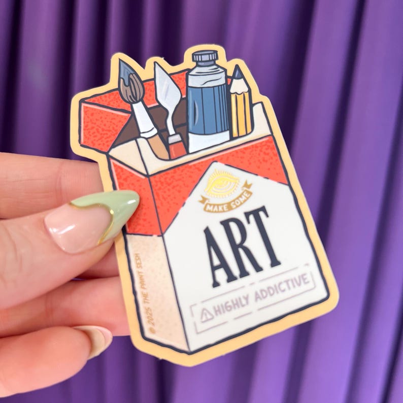 K&ouml;nnte beinhalten: Ein Aufkleber mit einem Zigarettenpackungsdesign mit Kunstutensilien im Inneren. Die Packung ist rot und wei&szlig;, mit dem Wort "ART" in fetten Buchstaben. Der Text "MAKE SOME" und "HIGHLY ADDICTIVE" ist ebenfalls sichtbar. Ein Pinsel, ein Spachtel, eine Farbtube und ein Bleistift sind innen.