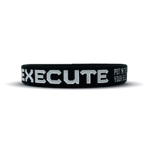 May include: Black silicone bracelet with the word "EXECUTE" in white lettering. The bracelet also has the text "PUT IN THE WORK, YOUR RESULTS WILL SPEAK FOR THEMSELVES" in smaller white lettering.