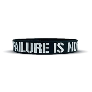 May include: Black silicone bracelet with the white text "FAILURE IS NOT"