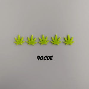 May include: Five green marijuana leaf stickers arranged in a row on a gray background. The text "90COE" is printed below the stickers.