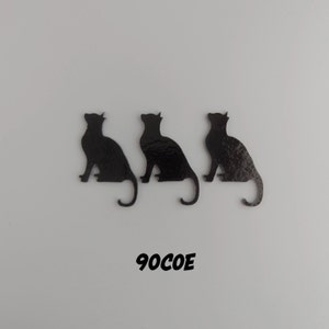 May include: Three black cat silhouettes in a row, each sitting with their tails curled. The cats are on a white background. The text "90COE" is printed below the cats.