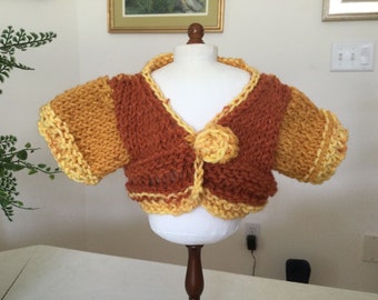 For 18” dolls like American Girl, a handknit shrug sweater in a rust to marigold to yellow colorway,rose knit button closing in front,unique