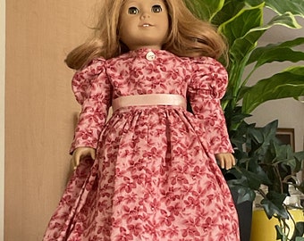 For an 18” doll,an old fashioned long daydress with puffed sleeves in a cranberry and pink floral print. Prairie,pioneer,1800s.Victorian