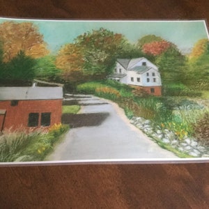 May include: A painting of a country scene with a white house, a red barn, and a winding road. The trees are in autumn colors, and the sky is blue.