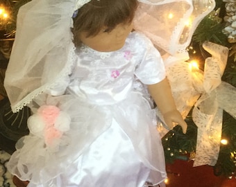 For 18” doll, an exquisite white bridal gown and veil, or Communion dress with white  satin slippers and  pink and white bouquet .