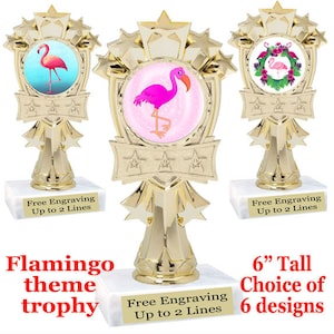 May include: Gold trophy with a flamingo theme. The trophy is 6 inches tall and has a choice of 6 designs. The trophy has a white base with the text "Free Engraving Up to 2 Lines".