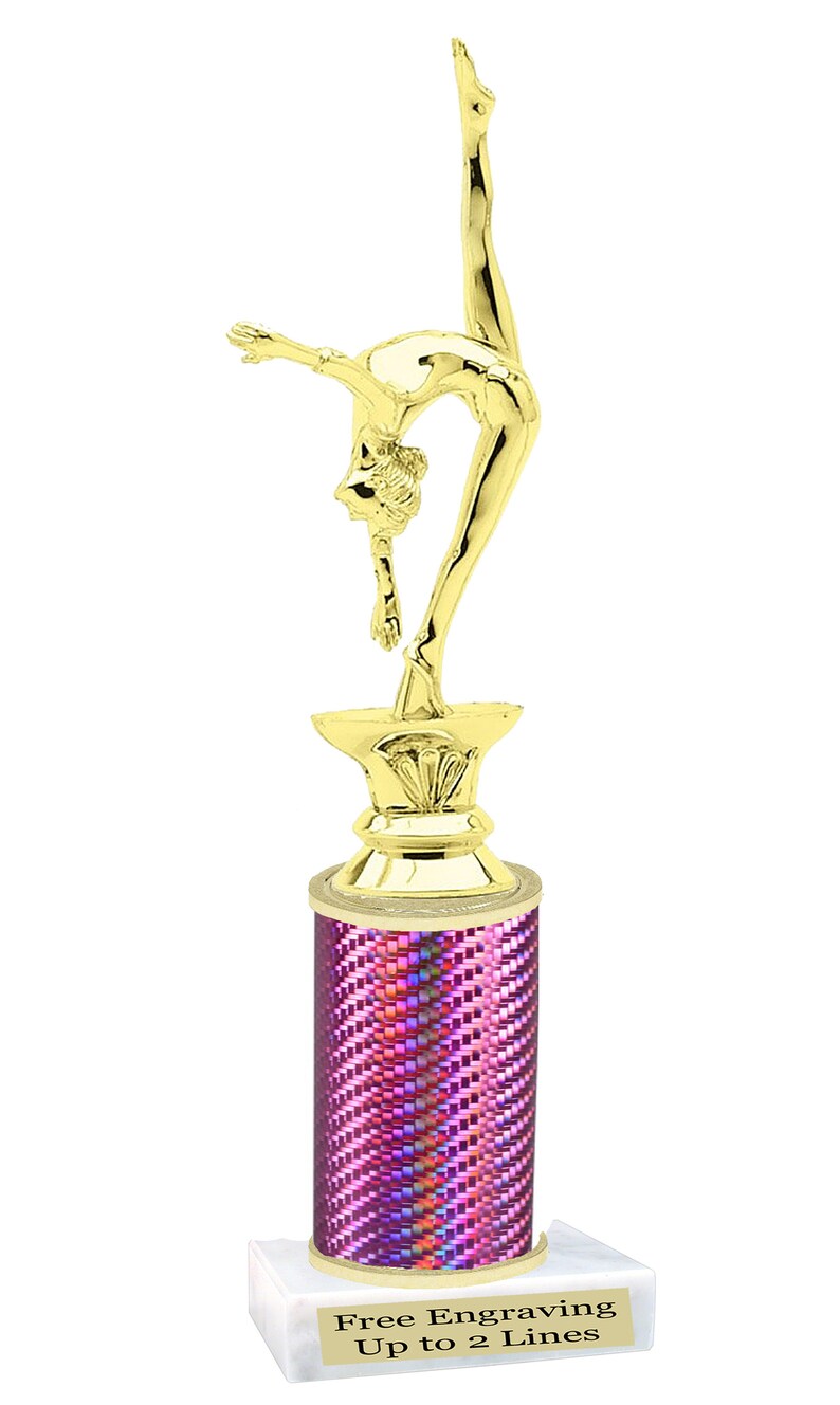 May include: Gold-colored trophy with a gymnast figurine on top. The base is a pink column with a white base. The base has the text "Free Engraving Up to 2 Lines".