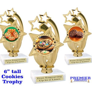 May include: A gold-colored 6-inch tall trophy with a star design and a round image of cookies. The base of the trophy is white and has the text "Free Engraving Up to 2 Lines".