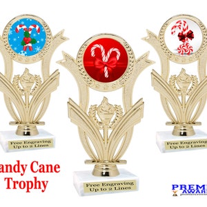 May include: Gold trophy with a red, white, and blue candy cane design. The trophy has a base with the text "Free Engraving Up to 2 Lines".