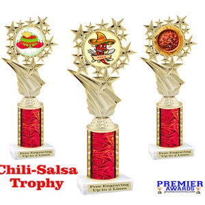 May include: Gold trophy with a red base and a star-shaped top. The top features a chili and salsa design. The trophy is labeled "Chili-Salsa Trophy" and "Free Engraving Up to 2 Lines".