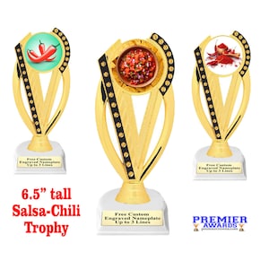 May include: Gold trophy with a salsa and chili pepper design. The trophy is 6.5 inches tall and has a white base with a black and gold trim. The base has the text "Free Custom Engraved Nameplate Up to 3 Lines".