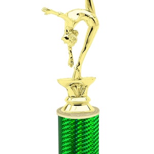 May include: Gold-colored trophy with a gymnast figurine on top. The base is a green cylinder with a white marble base. The base has the text "Free Engraving Up to 2 Lines".
