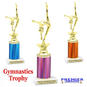 May include: Gold gymnastics trophy with a female gymnast figure on top. The trophy base is a column with a holographic finish in blue, purple, or orange. The base has a white marble square base with the text "Free Engraving Up to 2 Lines".