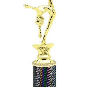May include: Gold-colored trophy with a gymnast figurine on top. The base is black with a rainbow iridescent pattern and a white marble base with the text "Free Engraving Up to 2 Lines".