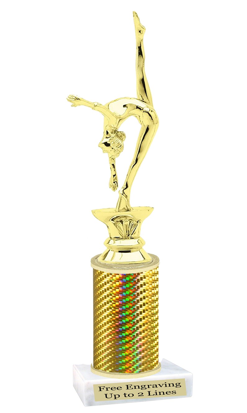 May include: Gold-colored trophy with a gymnast figure on top. The base is a column with a holographic finish and a white marble base. The base has the text "Free Engraving Up to 2 Lines".
