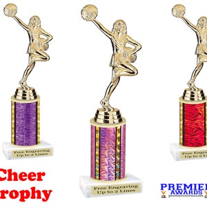 May include: Gold cheerleading trophy with a female figure holding pom-poms. The trophy has a purple, pink, and red base with the text "Free Engraving Up to 2 Lines".