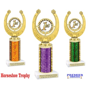 May include: Three gold horseshoe trophies with a 1st place design. The trophies have different colored bases: orange, purple, and green. Each trophy has a white base with the text "Free Engraving Up to 2 Lines".