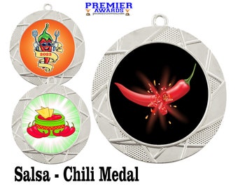 May include: Three silver medals with a chili pepper theme. The first medal features a cartoon chili pepper wearing sunglasses and a chef's hat. The second medal features a bowl of salsa with tortilla chips. The third medal features a red chili pepper exploding into pieces. The medals are for a salsa and chili competition.