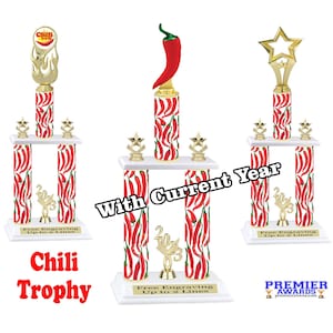 May include: Two-tiered chili pepper trophy with a red and white chili pepper design. The trophy has a gold base and a gold star on top. The trophy is engraved with "Free Engraving Up to 2 Lines".