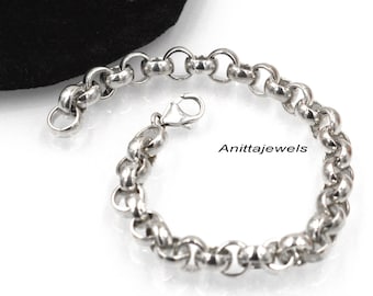 May include: A silver chain bracelet with a lobster clasp. The bracelet is made of a thick, textured chain.