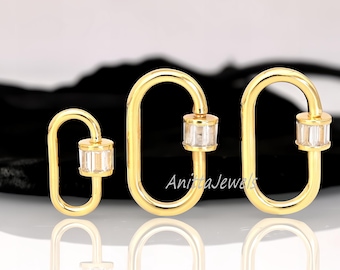 May include: Three gold-toned oval-shaped clasps with clear cubic zirconia stones. The clasps are different sizes.