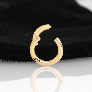 May include: Gold-toned metal ring clasp, a circular connector for jewelry making.