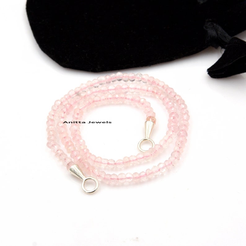 May include: A delicate pink rose quartz necklace with silver clasps. The necklace is made of small, round beads and is approximately 18 inches long.