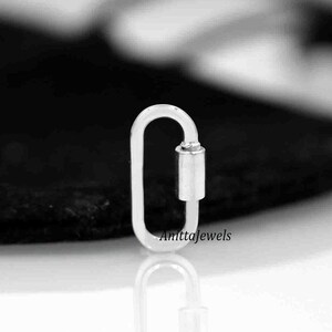 May include: Silver oval shaped lobster clasp with a silver toggle. The clasp is a popular jewelry finding used for necklaces, bracelets, and other jewelry projects.