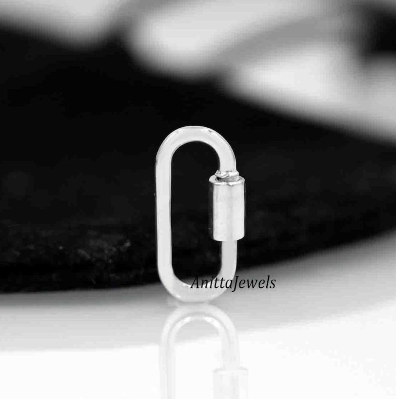 May include: Silver oval shaped lobster clasp with a silver toggle. The clasp is a popular jewelry finding used for necklaces, bracelets, and other jewelry projects.
