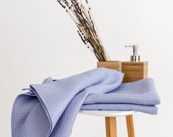 Waffle linen bath towels in pale periwinkle color. Washed linen hand towels