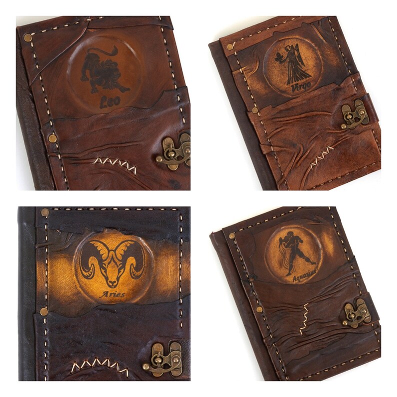May include: Four brown leather journals with zodiac signs embossed on the front. The signs are Leo, Virgo, Aries, and Aquarius.