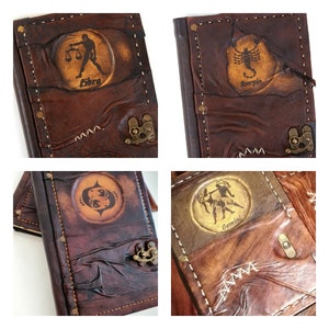 May include: Four brown leather journals with different zodiac signs embossed on the front. The signs are Libra, Scorpio, Gemini, and Pisces.