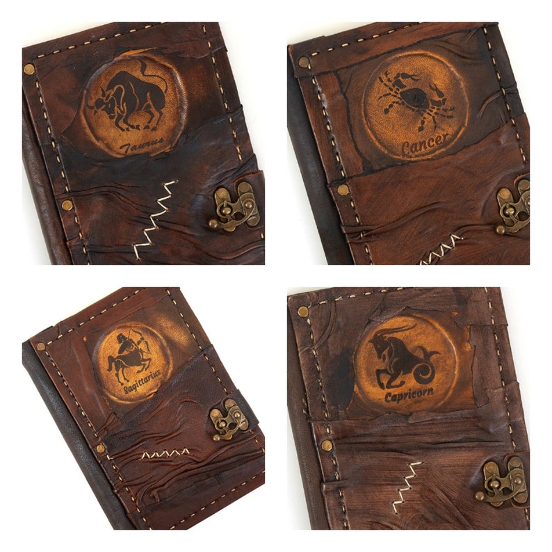 May include: Four brown leather journals with zodiac signs embossed on the front. The signs are Taurus, Cancer, Sagittarius, and Capricorn.