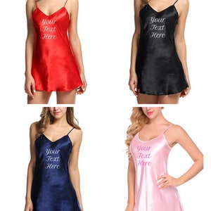 May include: Four satin sleep shirts in different colors: red, black, navy blue, and pink. Each shirt has a V-neck and thin straps. The text "Your Text Here" is embroidered on the front of each shirt.