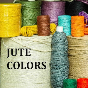 May include: A collection of spools of jute twine in various colors, including yellow, green, brown, purple, blue, orange, gray, beige, and natural. The spools are arranged in a row, and the text "JUTE COLORS" is printed on the front of the image.