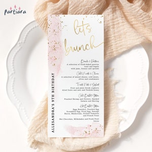 May include: A pink and gold watercolour background with gold glitter. The text "let's brunch" is written in gold script. The menu lists a variety of brunch items, including breads and pastries, cold meats and cheese, fruit and yogurt, cold buffet station, hot buffet station, and beverages. The text "Allesandra's 9th Birthday" is written in black on the left side of the menu.