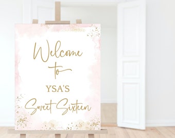 May include: Welcome to YSA's Sweet Sixteen sign with a pink and gold watercolor background. The sign is on an easel.