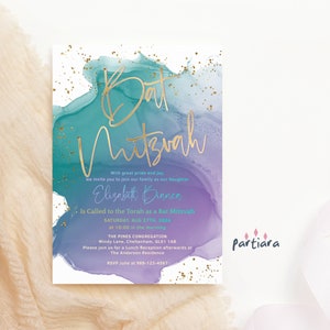 May include: Bat Mitzvah invitation with gold script text on a watercolor background of teal and purple hues. The invitation includes details for the event, such as the date, time, and location, with gold flecks scattered across the design.