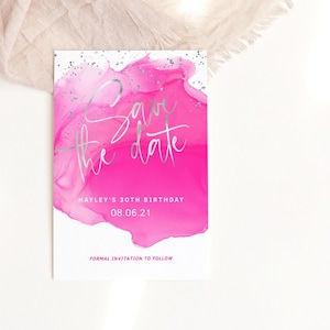 May include: Pink save the date card with silver foil lettering. The card features a pink watercolour design with silver glitter accents. The text reads "Save the Date" and "Hayley's 30th Birthday 08.06.21" with the words "Formal Invitation to Follow" at the bottom.