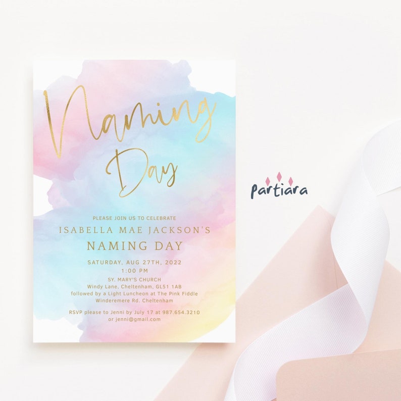 May include: A watercolor-style invitation with a gold foil inscription for a Naming Day celebration. The invitation features a rainbow watercolor background with the text "Naming Day" in gold foil lettering. The invitation includes the name Isabella Mae Jackson, the date and time of the event, and the location. The invitation also includes the text "RSVP please to Jenni by July 17 at 987.654.3210 or jenni@gmail.com".