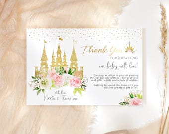 May include: A thank you card for a baby shower with a gold glitter castle and pink flowers. The text reads "Thank You for showering our baby with love!" and "with love, Natalie & Thanas xaxa".